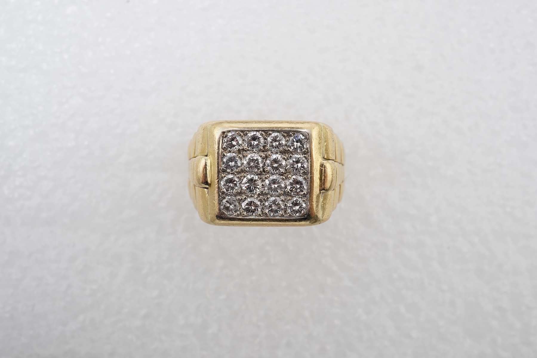 A gold and diamond signet ring